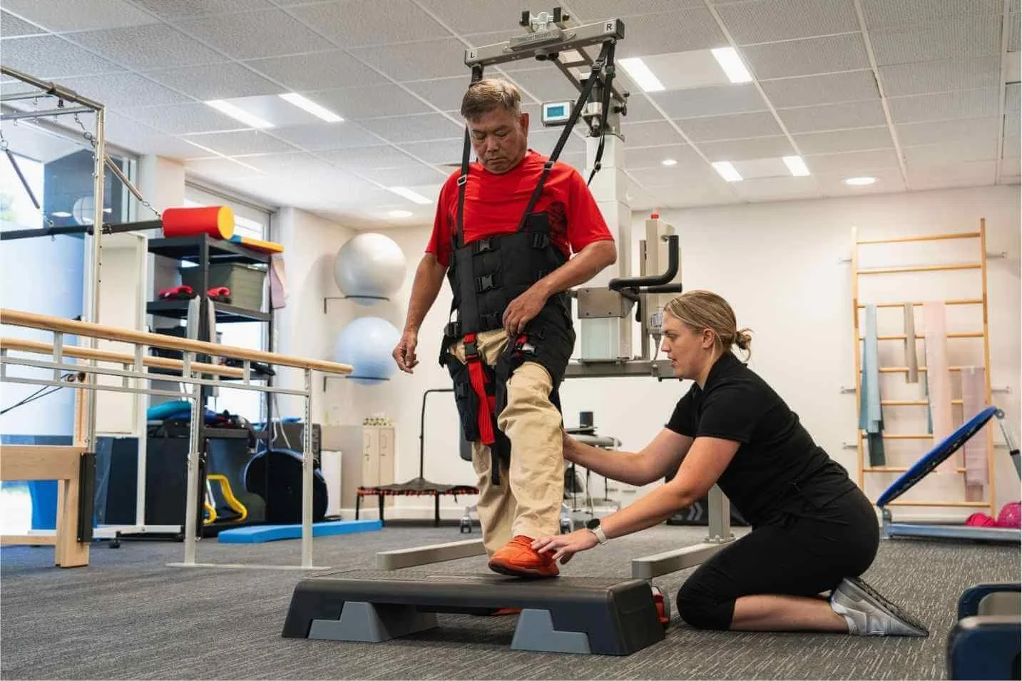 Caregiver assisting a client with a supported gait transfer